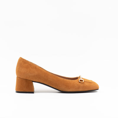 Heeled pump made from soft suede leather, featuring a square-shaped toe with a gold metallic horse-bit buckle